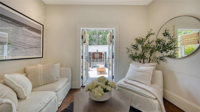 sitting room with dark wood-type flooring