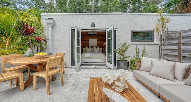 rear view of property with a patio area and outdoor lounge area