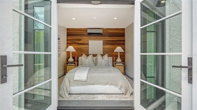 bedroom with a wall mounted AC and wood walls