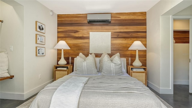 bedroom featuring wooden walls and a wall unit AC