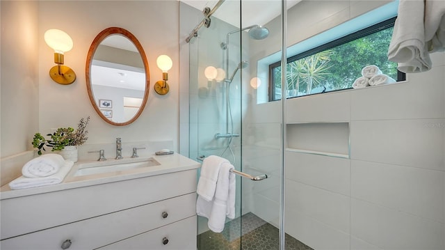 bathroom with vanity and a shower with door