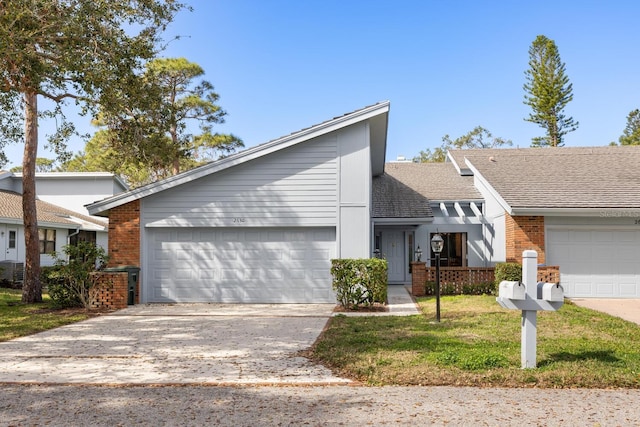 view of front of house featuring a garage and a front yard