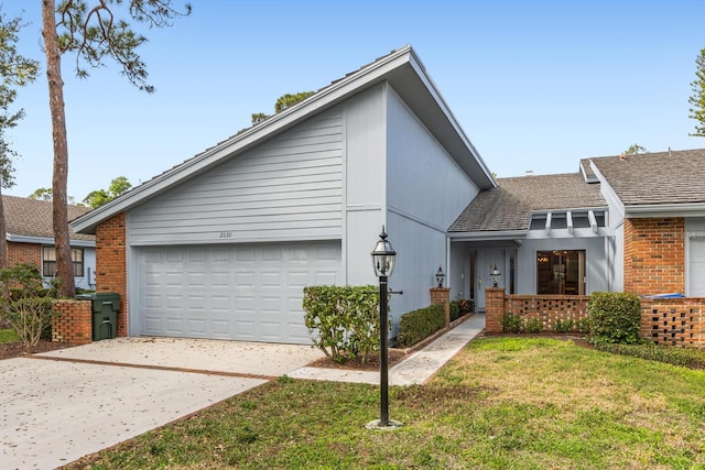 view of front of property with a garage and a front lawn