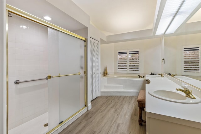 bathroom featuring hardwood / wood-style flooring, vanity, and independent shower and bath