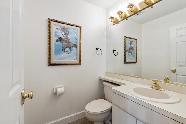 bathroom featuring vanity and toilet