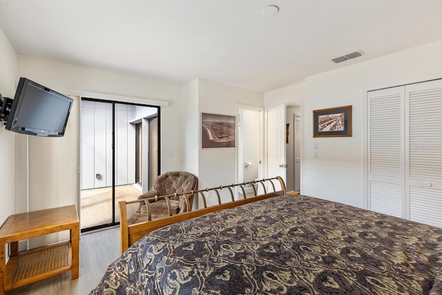 bedroom with light colored carpet and a closet