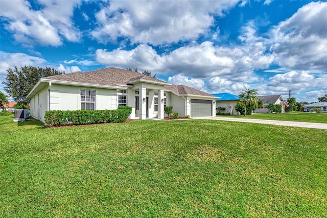 view of front of house featuring central AC unit, a garage, and a front yard