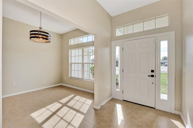 foyer entrance featuring light tile patterned flooring and a chandelier