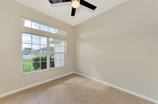 tiled empty room featuring ceiling fan