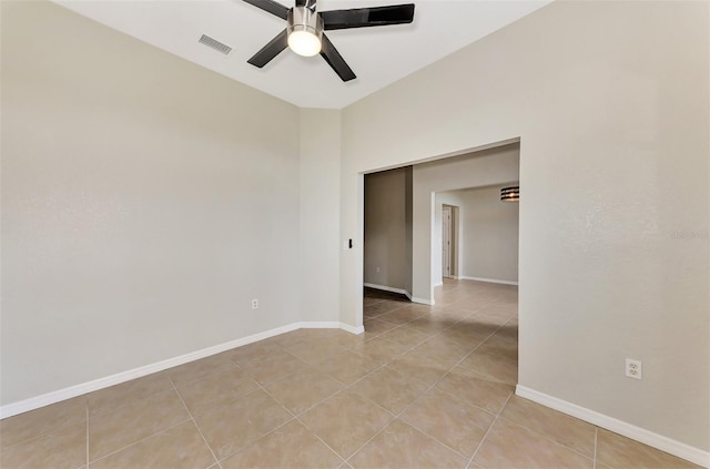 empty room with light tile patterned flooring and ceiling fan