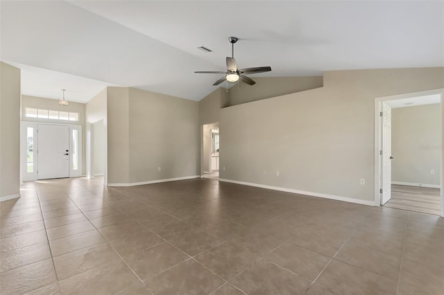 tiled empty room featuring vaulted ceiling and ceiling fan