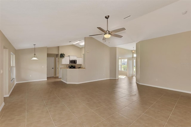 unfurnished living room with high vaulted ceiling, light tile patterned floors, and ceiling fan