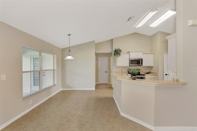 kitchen featuring pendant lighting, light tile patterned floors, stainless steel appliances, white cabinets, and kitchen peninsula