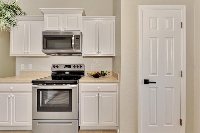 kitchen with white cabinetry and appliances with stainless steel finishes