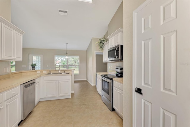 kitchen featuring sink, hanging light fixtures, kitchen peninsula, stainless steel appliances, and white cabinets