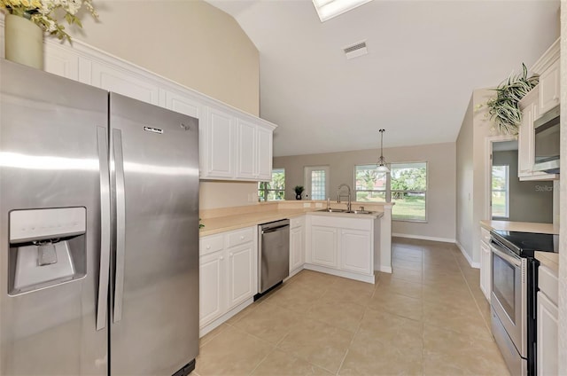 kitchen with sink, white cabinetry, appliances with stainless steel finishes, kitchen peninsula, and pendant lighting