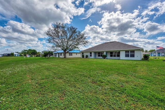 back of property featuring a yard