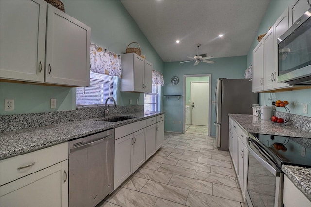 kitchen featuring sink, stainless steel appliances, and white cabinets