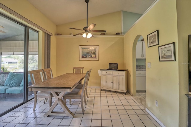 tiled dining space with ceiling fan and vaulted ceiling