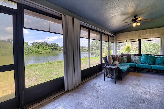 sunroom featuring a water view, ceiling fan, and vaulted ceiling