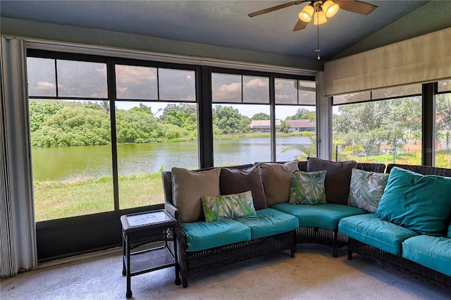 sunroom / solarium featuring a water view, ceiling fan, and vaulted ceiling