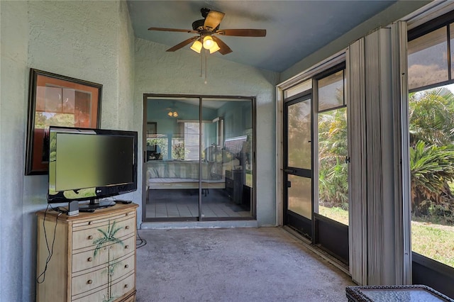 sunroom featuring ceiling fan, vaulted ceiling, and a wealth of natural light