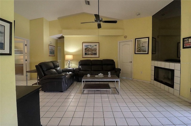 living room featuring light tile patterned floors, high vaulted ceiling, a tile fireplace, and ceiling fan