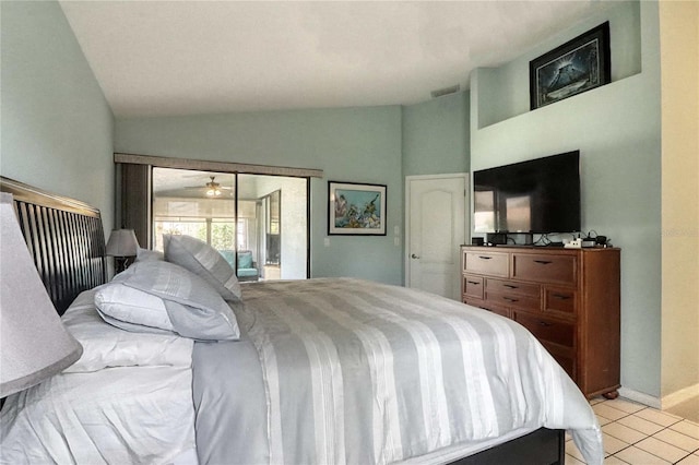 bedroom with access to exterior, vaulted ceiling, and light tile patterned floors