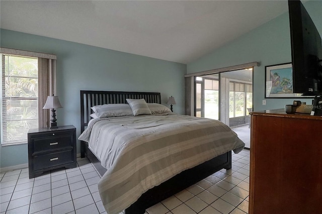 bedroom with access to exterior, vaulted ceiling, and light tile patterned flooring