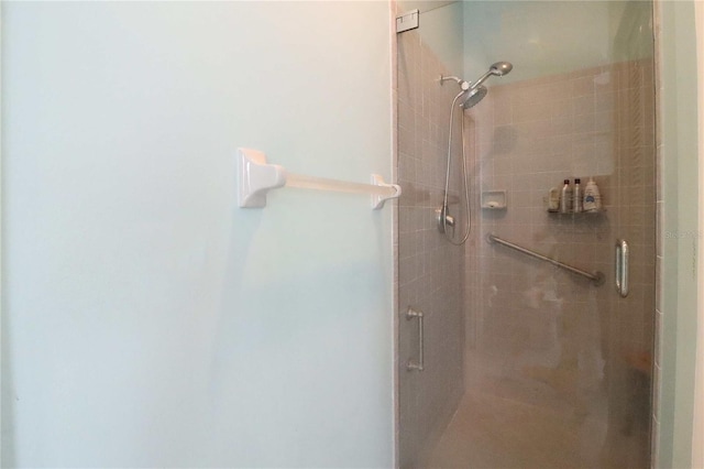 bathroom featuring a shower with door