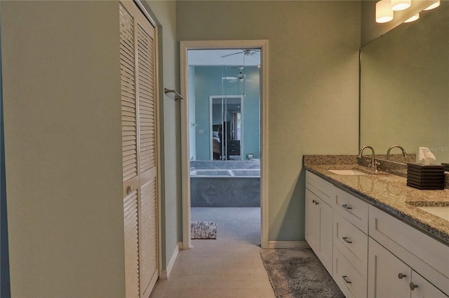 bathroom featuring ceiling fan and vanity