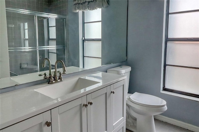 bathroom featuring walk in shower, vanity, and toilet