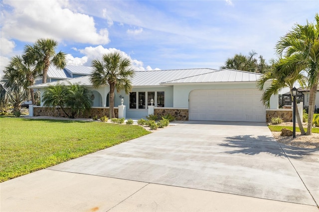 ranch-style house featuring a garage and a front lawn