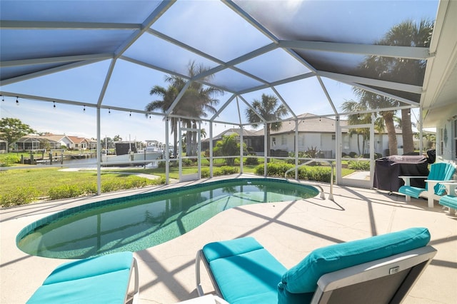 pool with glass enclosure, a residential view, and a patio area