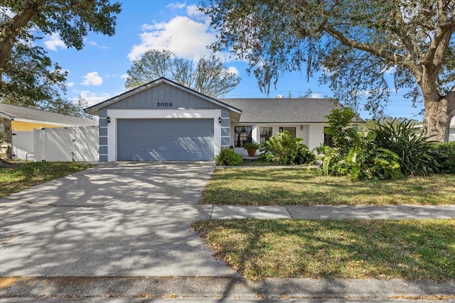 ranch-style house with a garage and a front yard