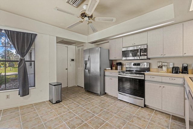 kitchen featuring stainless steel appliances, light tile patterned floors, and ceiling fan