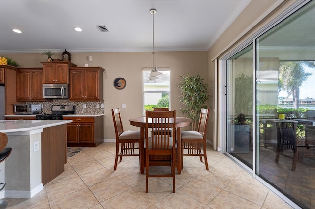 kitchen with stainless steel appliances, light countertops, visible vents, decorative backsplash, and ornamental molding