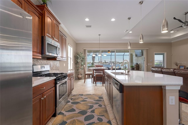 kitchen featuring a sink, a healthy amount of sunlight, ornamental molding, appliances with stainless steel finishes, and backsplash