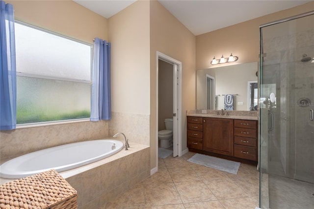 bathroom featuring tile patterned flooring, a garden tub, toilet, vanity, and a stall shower