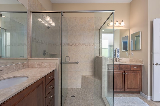 bathroom with two vanities, a sink, and a shower stall