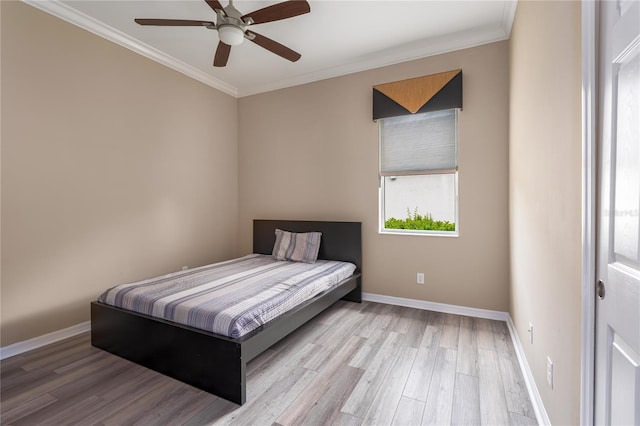 bedroom featuring crown molding, baseboards, ceiling fan, and wood finished floors