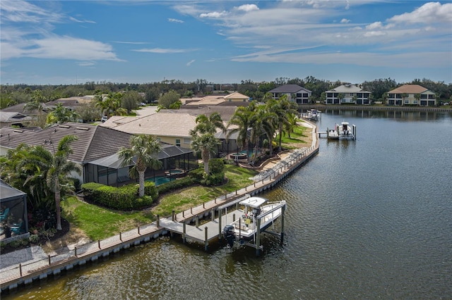 birds eye view of property featuring a water view and a residential view