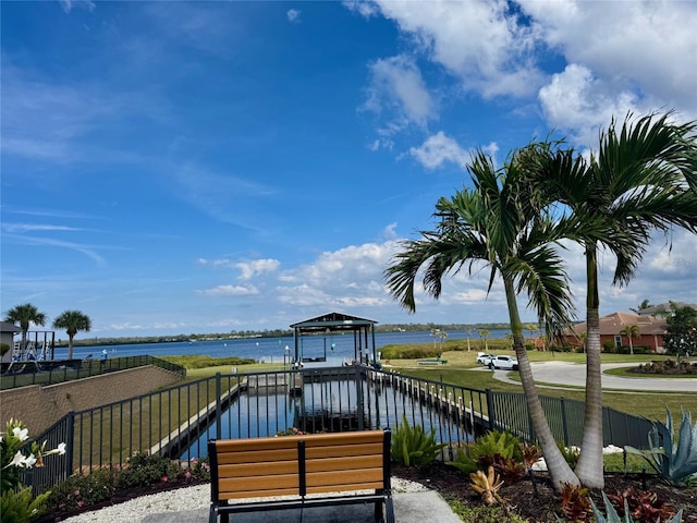 exterior space with a water view and fence