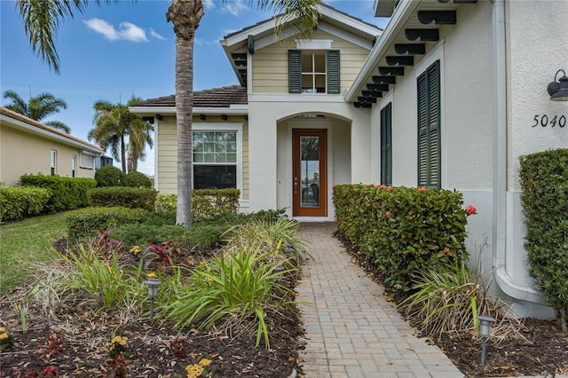 entrance to property with stucco siding