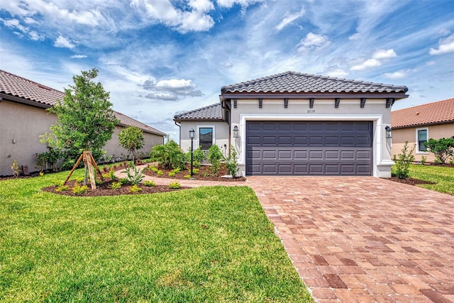 16119 Fortezza Dr, Bradenton, FL 34211 - mediterranean / spanish-style home featuring a garage and a front lawn
