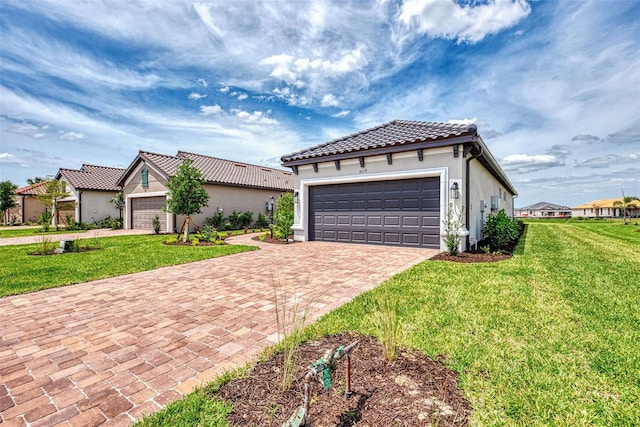 mediterranean / spanish house with a garage and a front yard