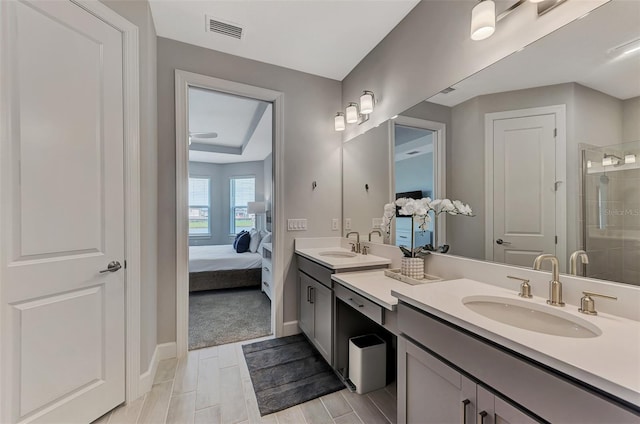 bathroom featuring vanity and a shower with shower door