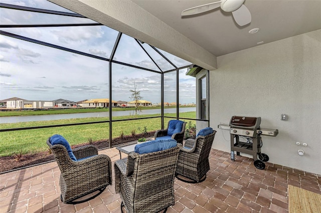 view of patio with a grill, a lanai, ceiling fan, and a water view