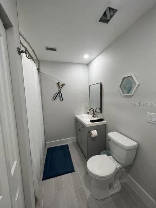 bathroom with toilet and vanity