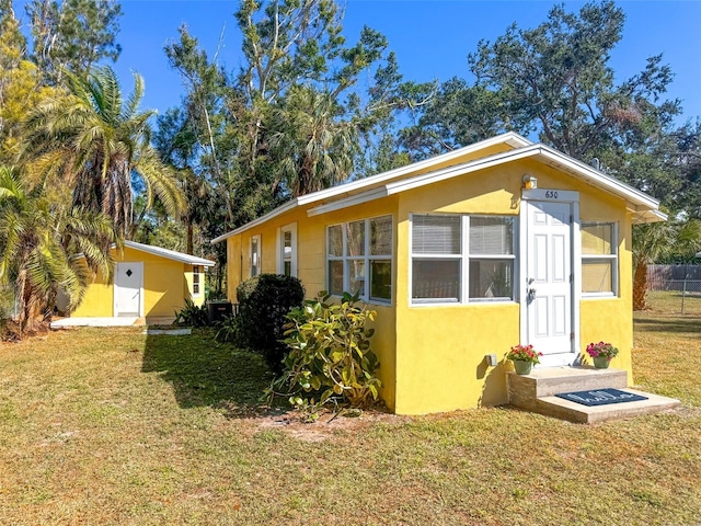 view of side of property featuring an outdoor structure and a lawn